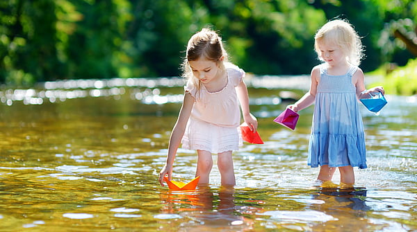 Two little girls play in the river