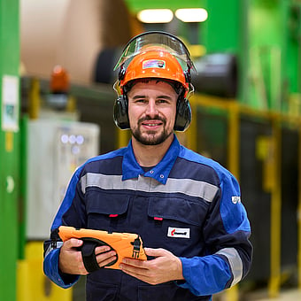 male production worker with a safety helmet