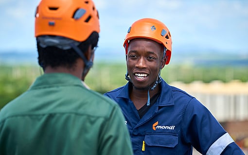 two production worker wearing a safety helmet