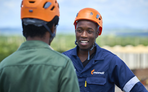 two production worker wearing a safety helmet