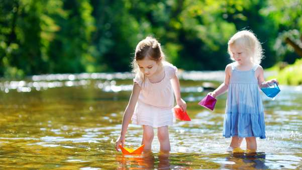 Two little girls play in the river