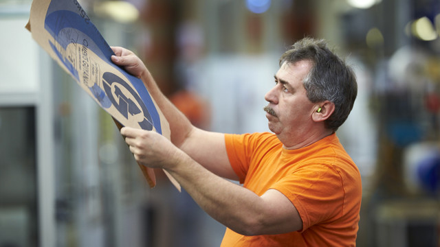 production worker with paper bags