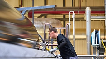 A man is operating a paper machine.