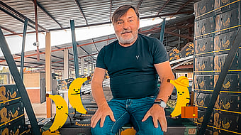 Marek Motylewski from Mondi, surrounded by corrugated boxes filled with bananas.