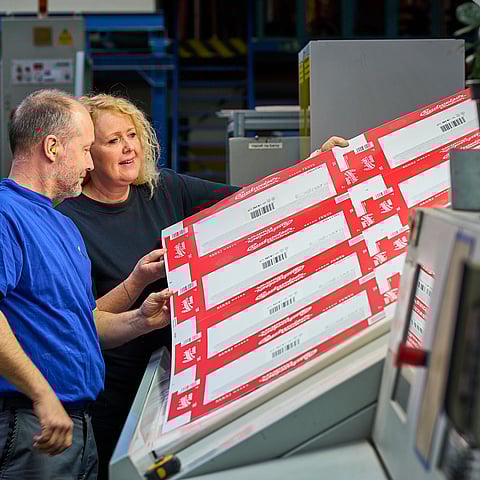 male and female worker checking product quality