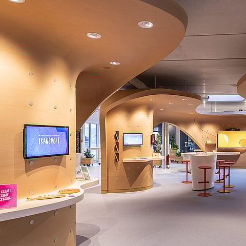 Interior of a Mondi's FlexStudios with interactive displays and seating areas.