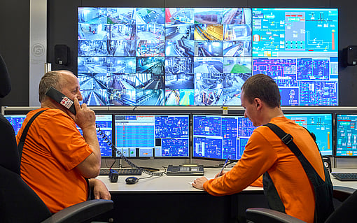 two production workers in the monitoring room