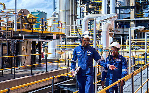 Two engineers inspecting the exterior of a pulp mill