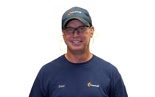 shoulders up shot of man with protective glasses, wearing blue t-shirt and baseball cap
