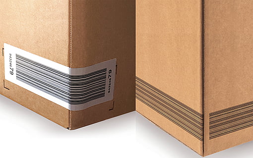 Two corrugated boxes: one has a barcode label attached to it, and the other has a barcode printed on it.