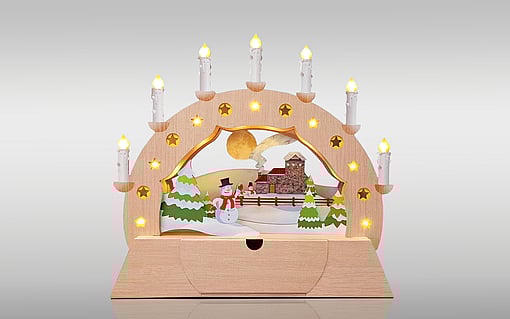 The image displays an example of intricate die-cutting technology: a Christmas arch decorated with lights.