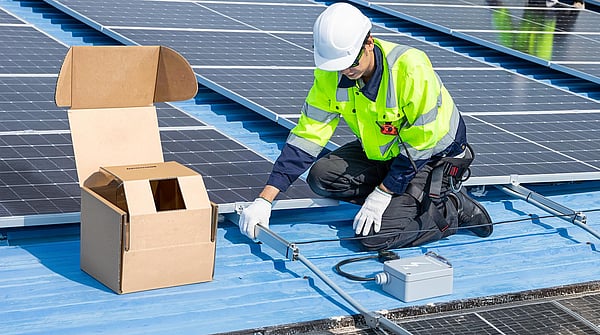 man in safety clothing and hard hat working with tools