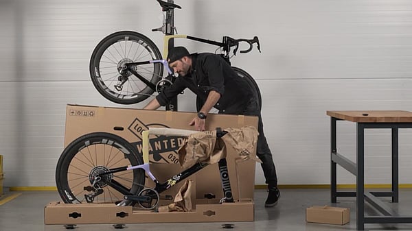 A man is removing the bike packaging made by Mondi.