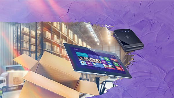 eCommerce shipping scene that shows a warehouse with electronic devices ready for shipping in a corrugated box.
