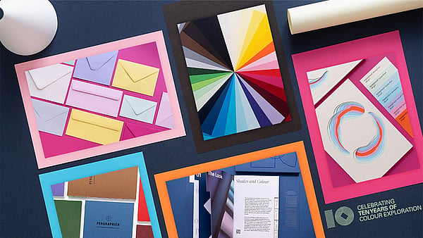packshots of colourful printing paper on a black background