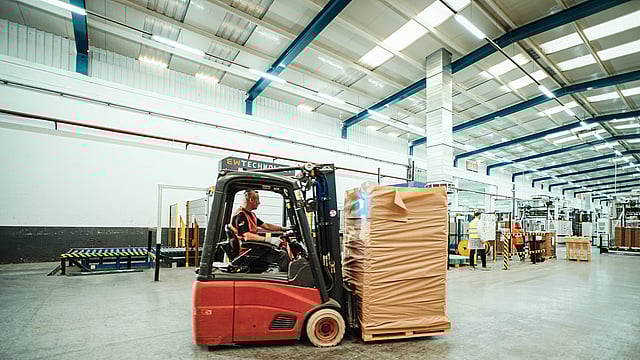 Woman touching pallet wrapped in paper