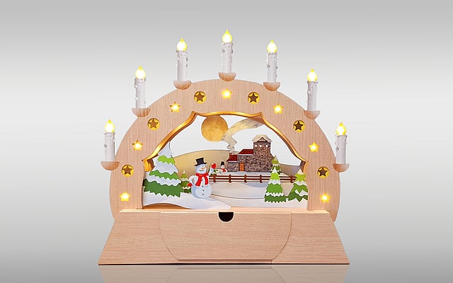 The image displays an example of intricate die-cutting technology: a Christmas arch decorated with lights.