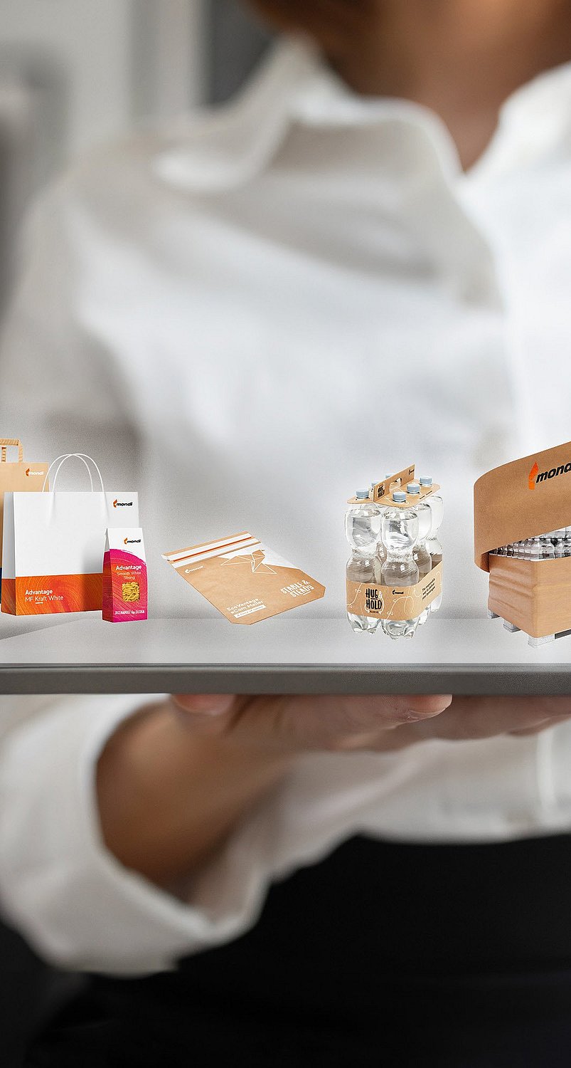 Illustration of a tablet displaying packaging products and sustainability icons, representing Kraft Paper packaging solutions.