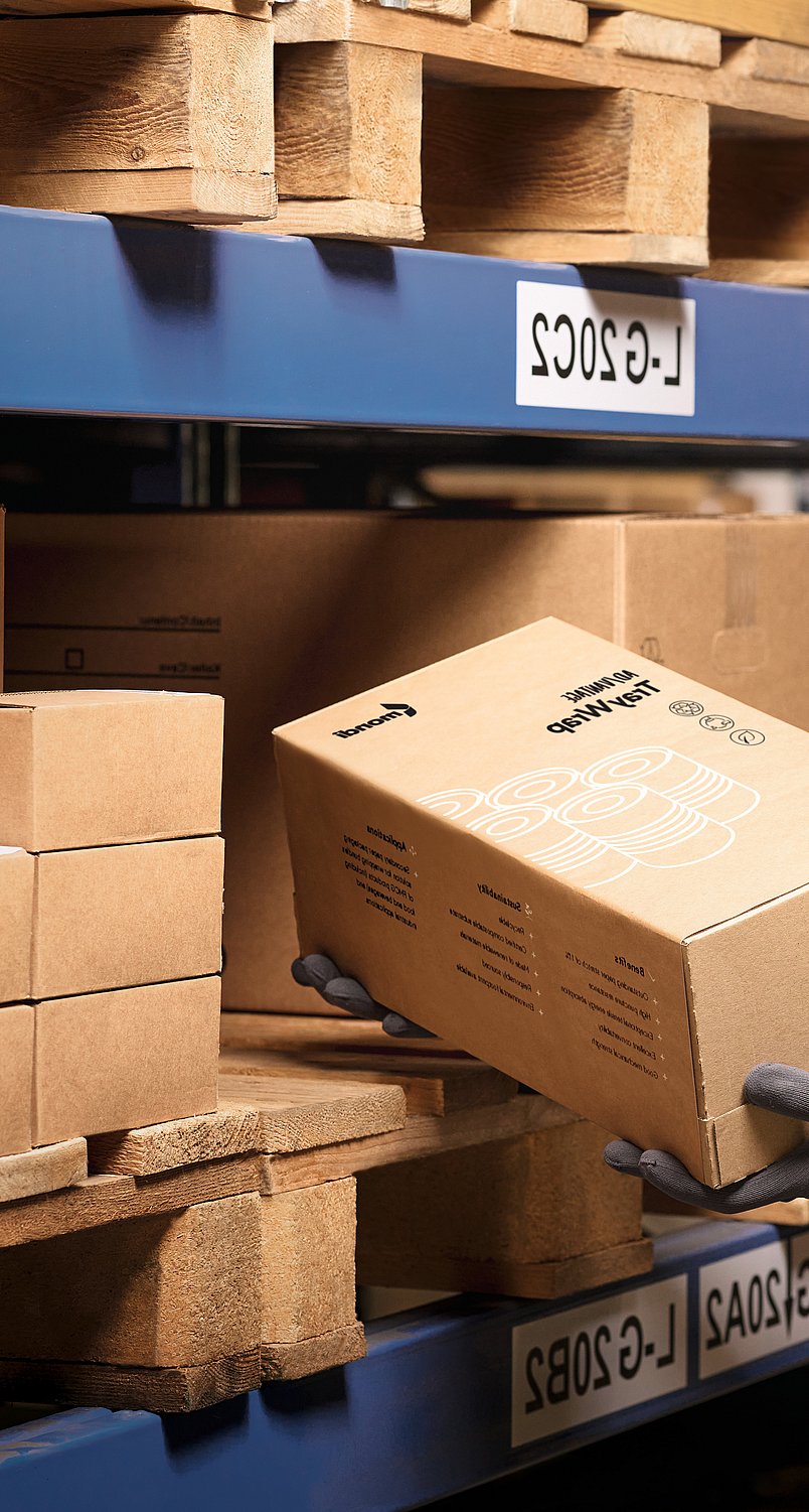 warehouse worker examining cardboard box