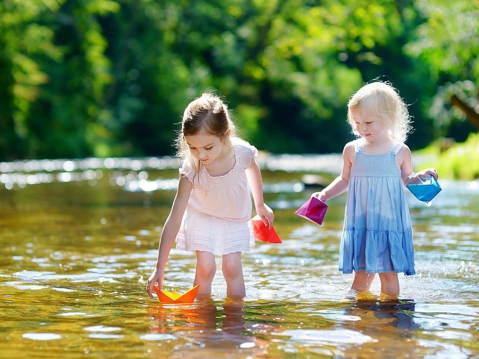 Two little girls play in the river