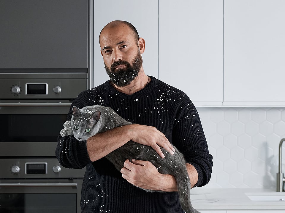 Man with cat covered in polystyrene