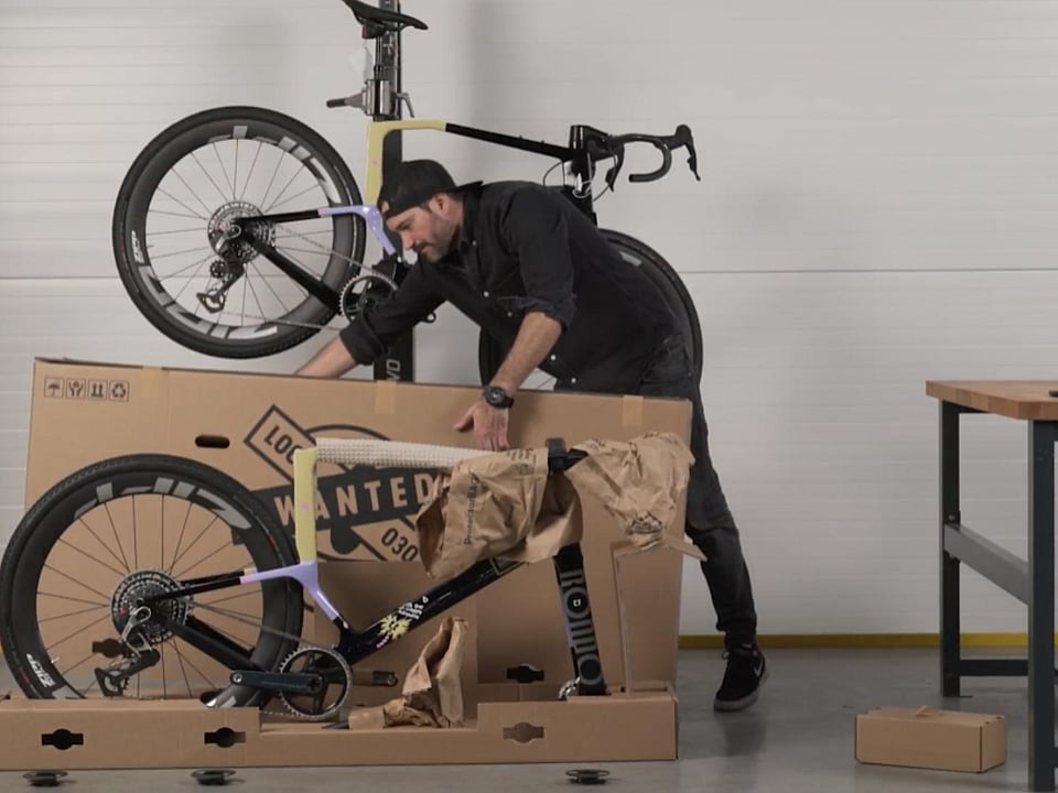 A man is removing the bike packaging made by Mondi.
