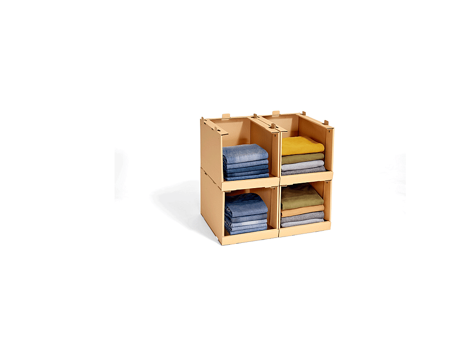 Shelf made of corrugated cardboard filled with sweaters.