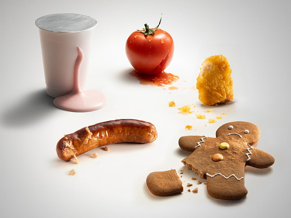 gingerbreadman with broken foot, tomato, spilled milkshake and chicken nugget on a white background