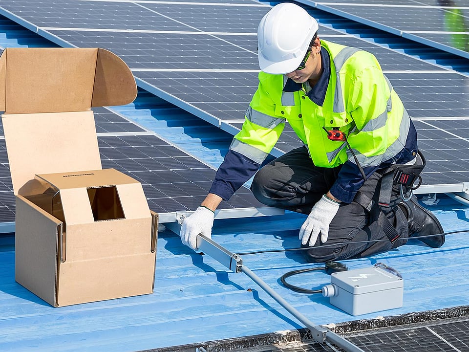 man in safety clothing and hard hat working with tools