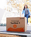 A woman walks into a house. At the doorstep lies a brown corrugated box with the writing ProVantage Testliner 3.