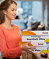 A woman holding a corrugated box with the words ProVantage SmartKraft White written on it.