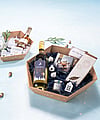 Corrugated gift baskets filled with Christmas presents such as chocolate, alcohol, and jam.