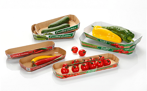 A selection of five punnets, made from corrugated and solid board, each containing different vegetables.
