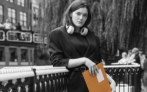 A woman holding a mailer.