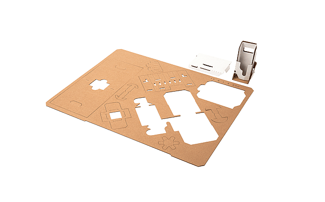 A corrugated board with die cutting lines and the final packaging product placed next to the board.