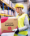 A woman in a warehouse holding a corrugated box with the words ProVantage Kraftliner written on it.