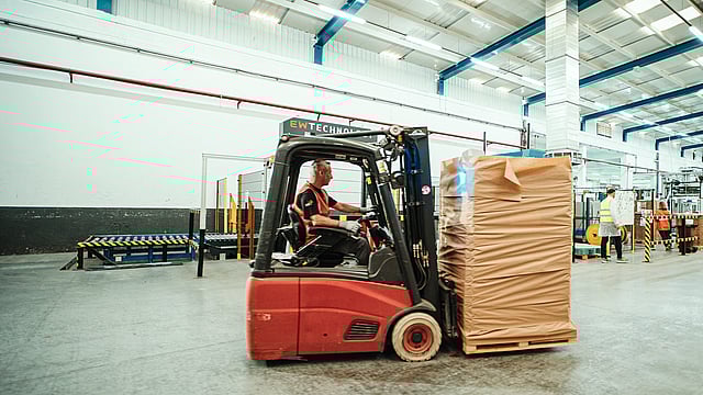 Woman touching pallet wrapped in paper