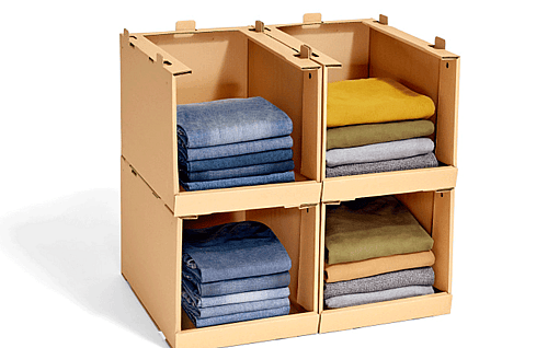 Shelf made of corrugated cardboard filled with sweaters.