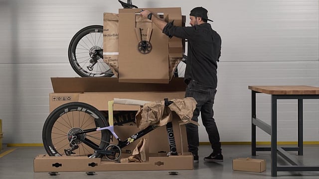 A man unboxing a bike with packaging made by Mondi.