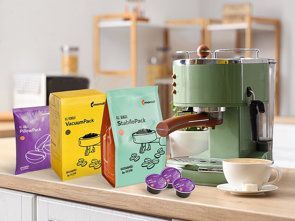 Image of four different packaging solutions for coffee storage, sitting next to a coffee machine.